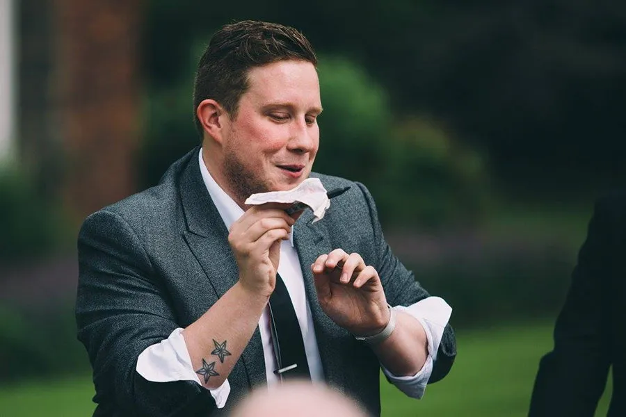Mark Waddington in a grey suit performing outdoors