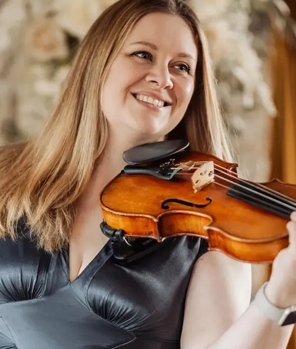 Emily playing the violin indoors.