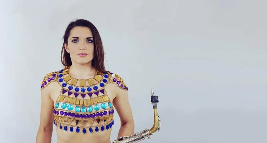 Ellie Sax holding her saxophone.